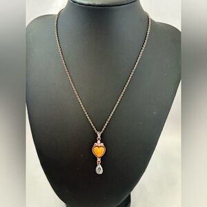 1928 heart pendant necklace in brass tone with a butterscotch acrylic heart